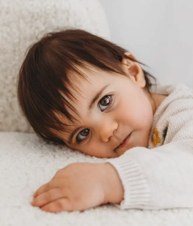 baby girl with big brown eyes looking straight into the camera