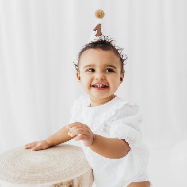baby portrait in first birthday session in bright white studio
