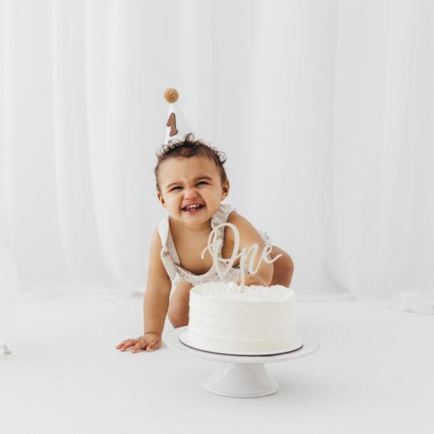 Baby during a first birthday cake smash photoshoot in Rugby Warwickshire
