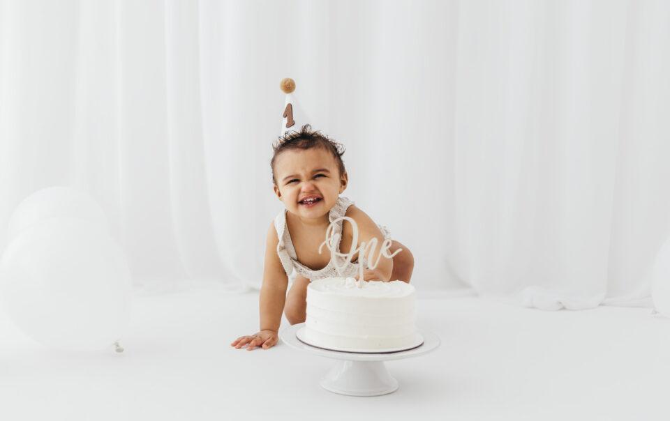 Baby during a first birthday cake smash photoshoot in Rugby Warwickshire