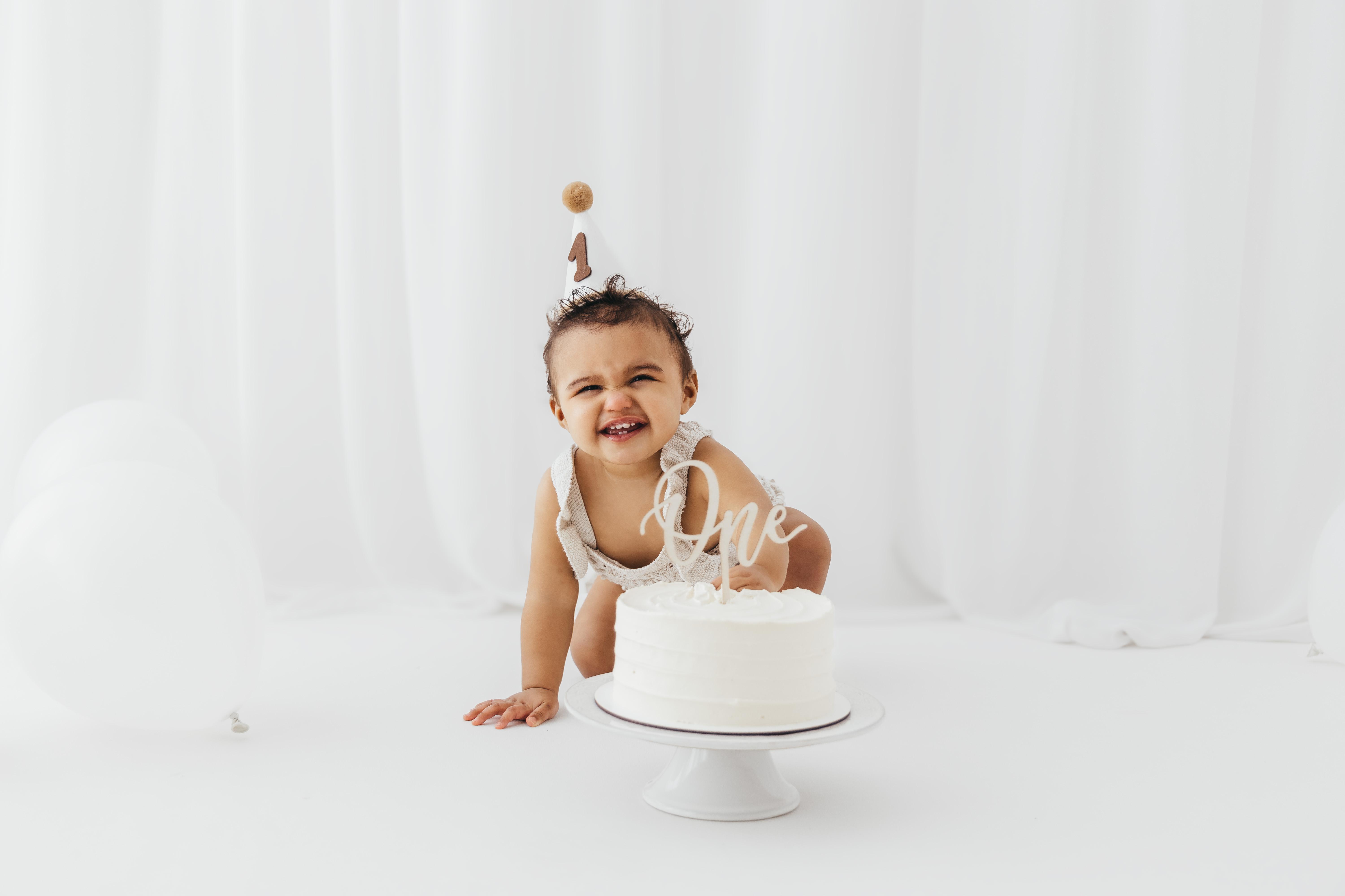 Baby during a first birthday cake smash photoshoot in Rugby Warwickshire