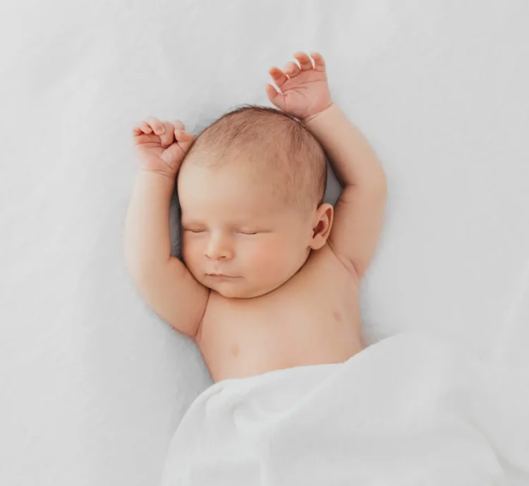 2025_08_17_4996 Newborn baby sleeping with his arms above his head and covered with a white blanket Photography Rugby Warwickshire